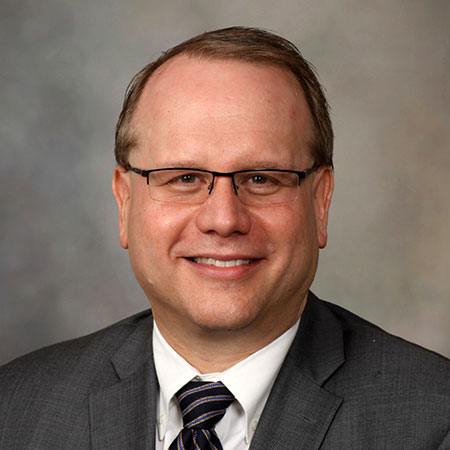 Dr. Erik K. St. Louis, M.D.